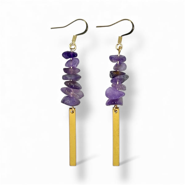 Pair of purple stone and gold bar earrings on a white background