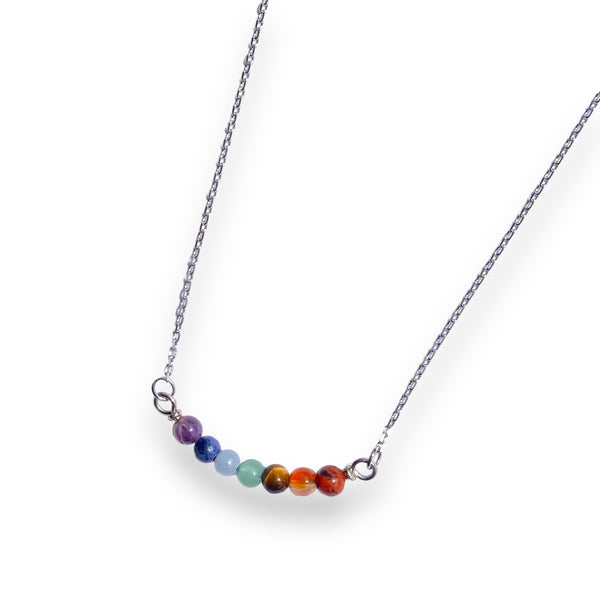 Silver stainless steel necklace with multicolored gemstones in a horizontal pendant for self love, pride, and spirituality.