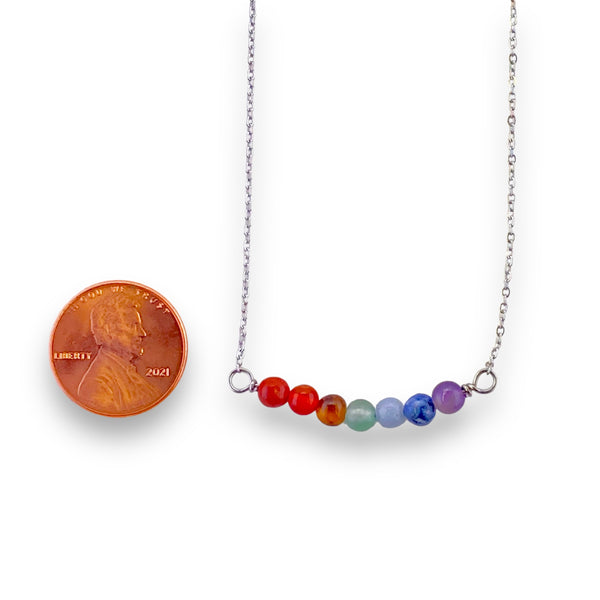 Silver stainless steel necklace with multicolored gemstones in a horizontal pendant for self love, pride, and spirituality.