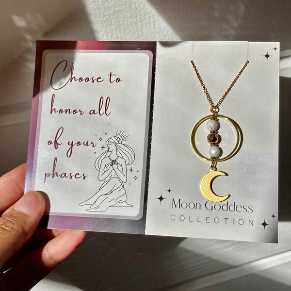 gold moon necklace with white howlite gemstones and gold crescent moon on a jewelry card with a positive affirmation